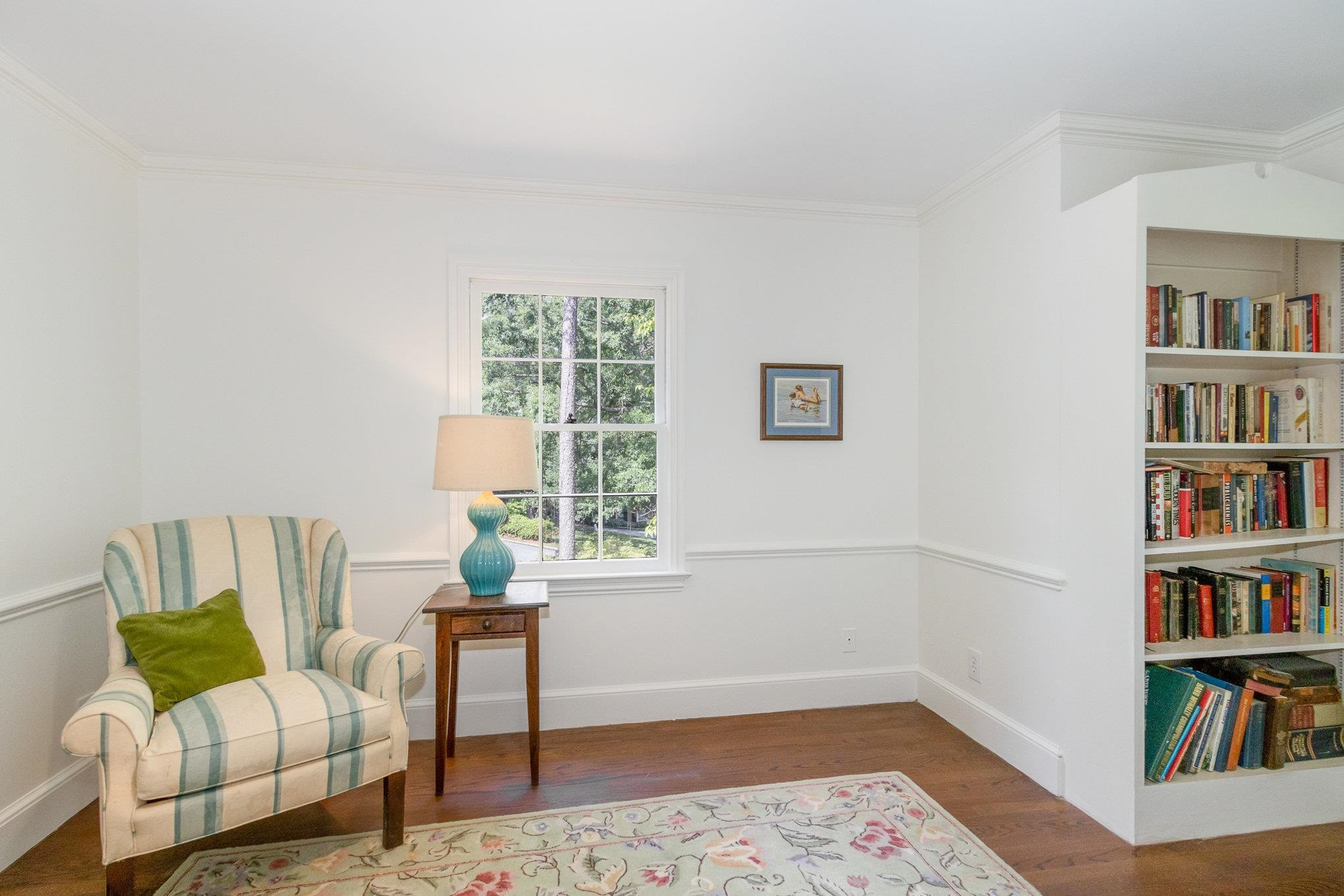 3327 Landor Road Raleigh, NC 27609 - Photo 43 of 60 a living room with furniture and a book shelf