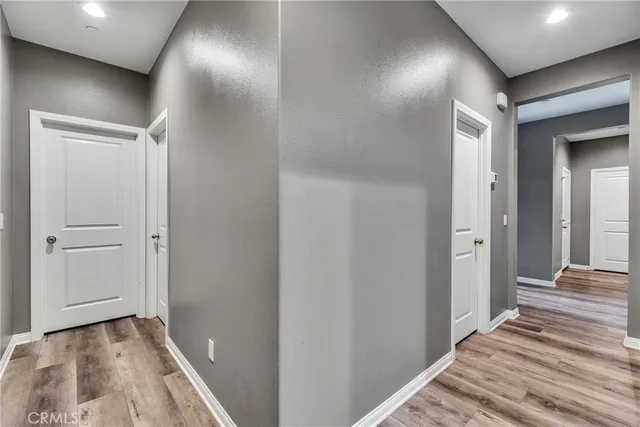 a view of a hallway with wooden floor