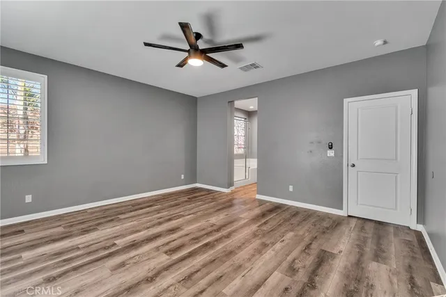 a view of a livingroom with a ceiling fan and window