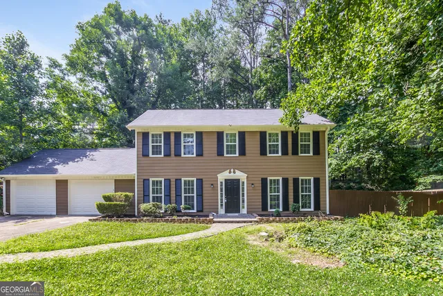a front view of a house with a yard table and chairs