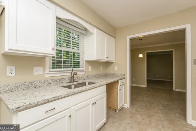 a kitchen with granite countertop a sink and a granite counter tops