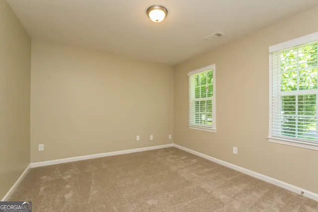 an empty room with windows and closet