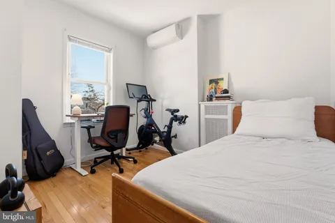 a bed room with a bed and a desk