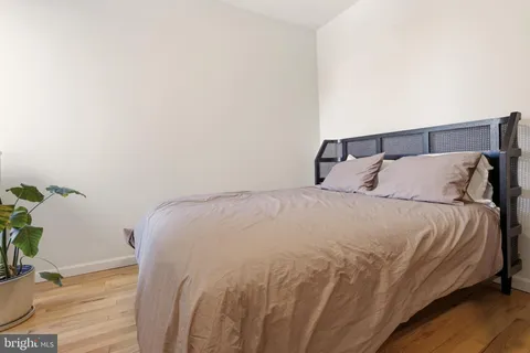 a large bed sitting in a bedroom next to a window