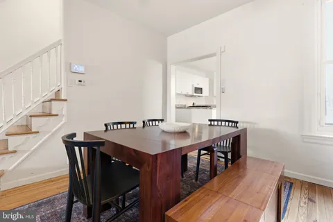 a dining room with furniture and wooden floor