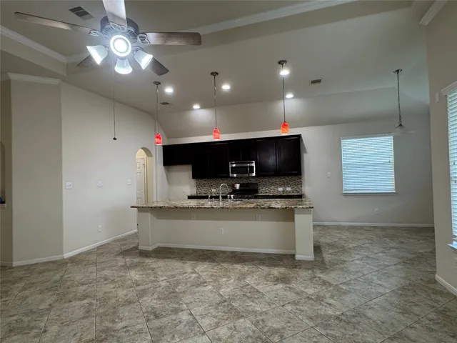 a view of kitchen with microwave and stove