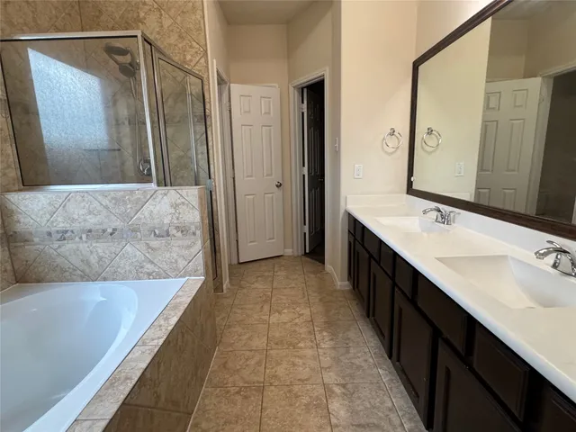 a bathroom with a double vanity sink and a mirror