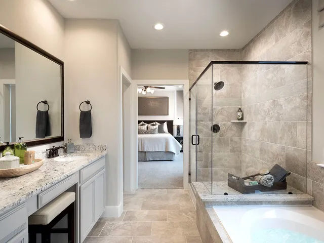a bathroom with a granite countertop sink mirror and shower