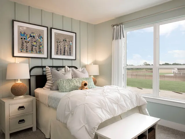 a bedroom with double bed and a large window