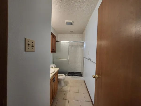 a bathroom with a toilet and a shower