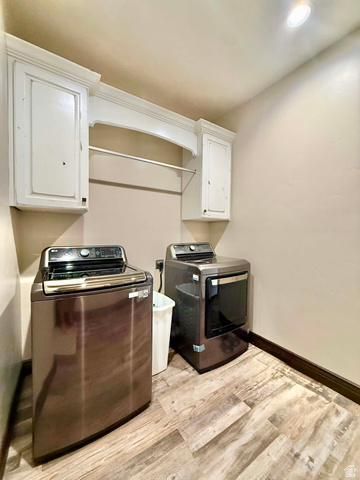 2101 Goose Ranch Road Vernal, UT 84078 - Photo 49 of 72 Dedicated laundry area featuring wood-finish flooring, white cabinetry, and a clothing rod