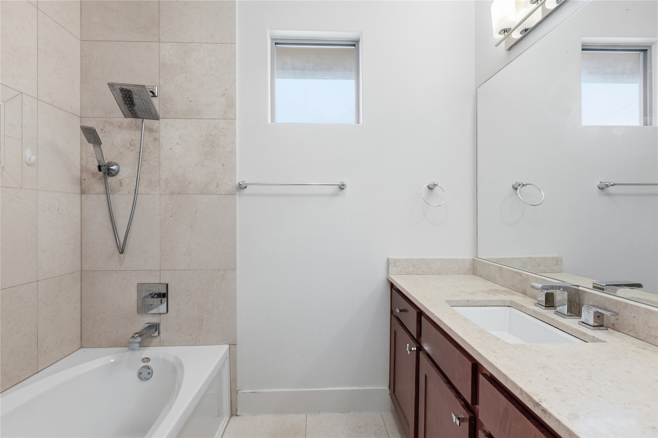 4124 Valley View Road, Unit 4A & 4B Austin, TX 78704 - Photo 20 of 40 Clean, contemporary bathroom featuring a practical bathtub with an overhead shower and a spacious vanity.