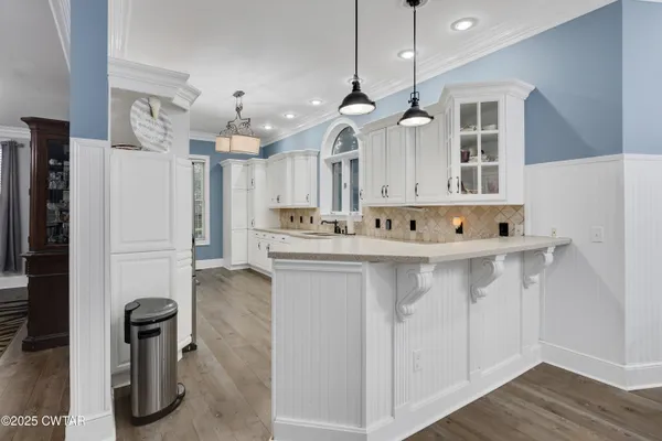 a kitchen with stainless steel appliances granite countertop a sink and a refrigerator