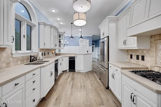 a kitchen with cabinets oven appliances and a counter space