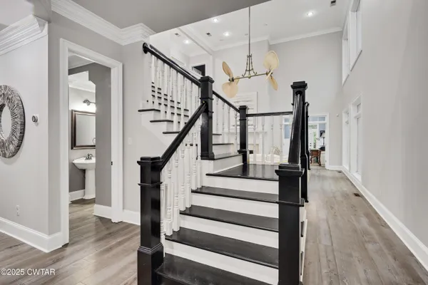 a view of entryway and hall with wooden floor