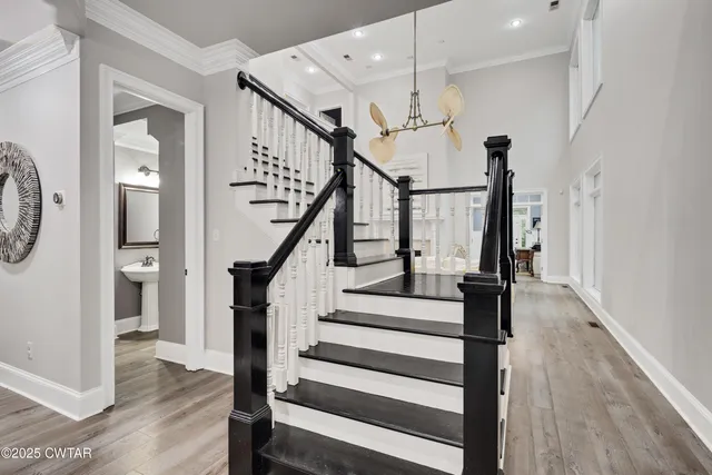 a view of entryway and hall with wooden floor
