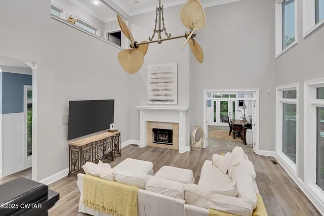 a living room with furniture a fireplace and a flat screen tv