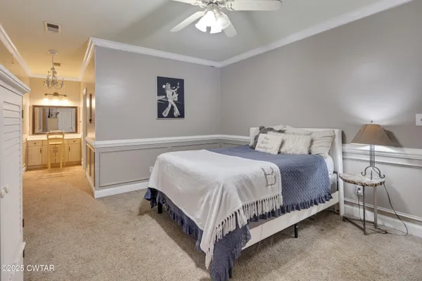 a bedroom with a bed and a chandelier