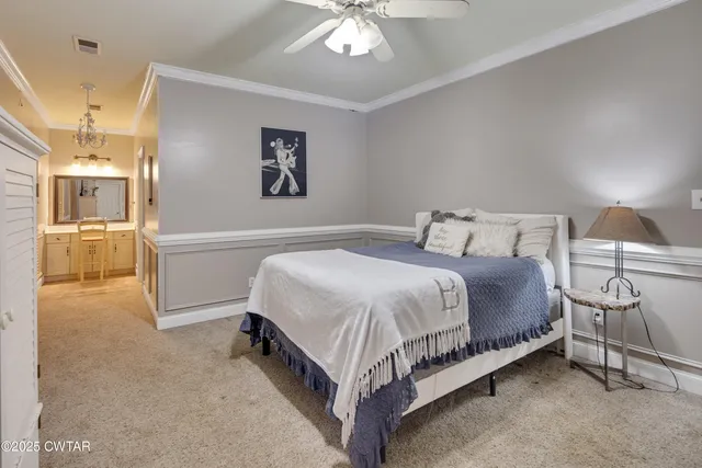 a bedroom with a bed and a chandelier