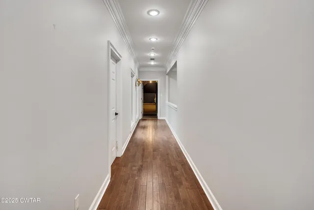 a view of hallway with wooden floor
