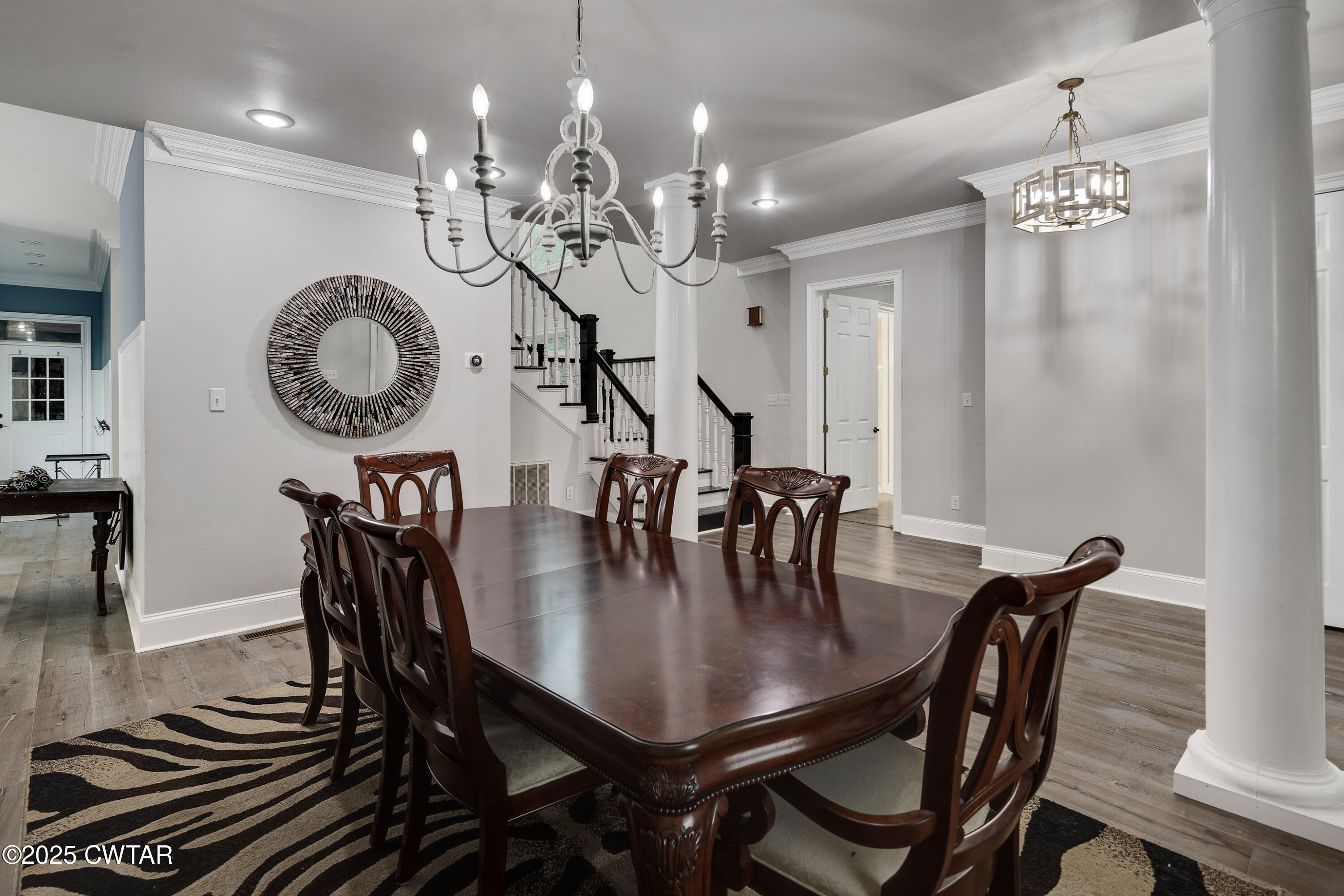 51 Crownpointe Cove Jackson, TN 38305 - Photo 6 of 25 a dining room with wooden floor a chandelier a wooden table and chairs