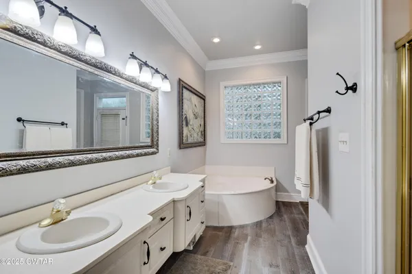 a bathroom with a double vanity sink a mirror and a toilet