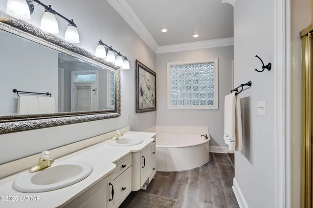 a bathroom with a double vanity sink a mirror and a toilet