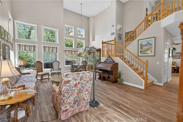 a living room with furniture a flat screen tv and kitchen view