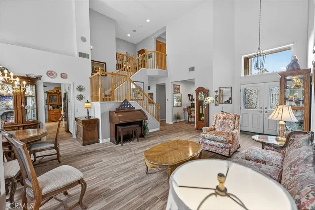 a view of a patio with table and chairs potted plants and floor to ceiling window