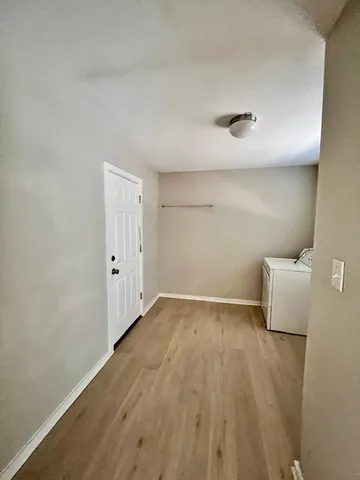 a view of an empty room and wooden floor