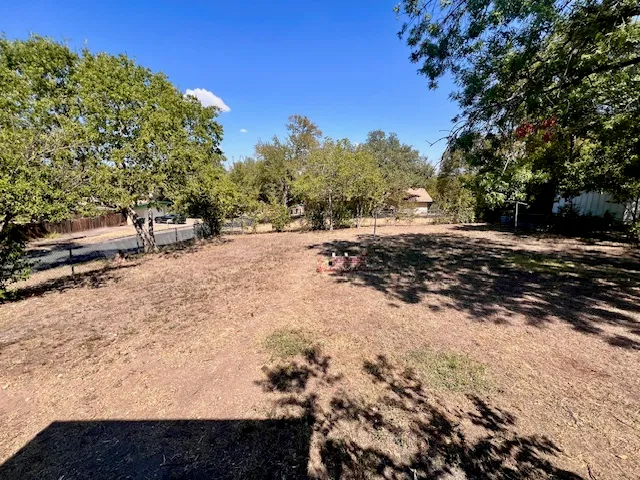a view of a yard with trees