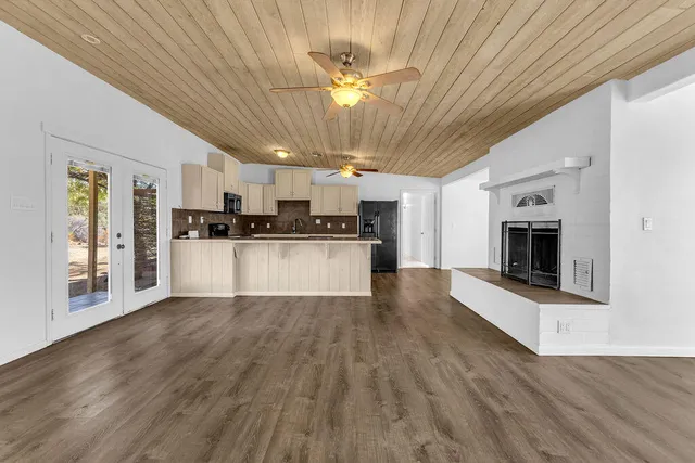 a kitchen with stainless steel appliances granite countertop a refrigerator a stove top oven a sink and dishwasher