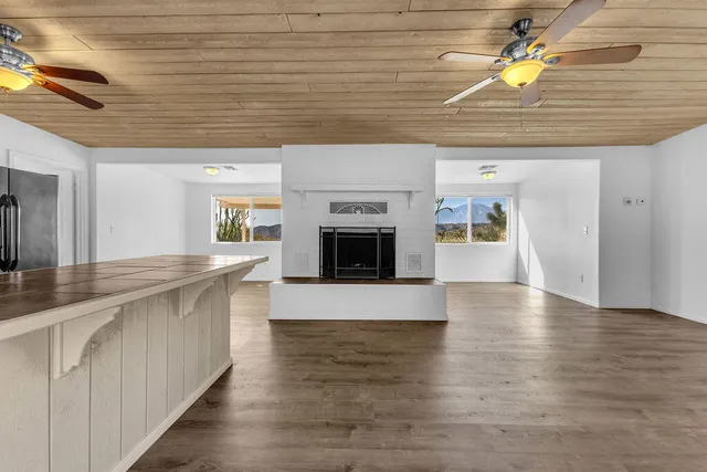 a open kitchen with a sink and dishwasher with white cabinets