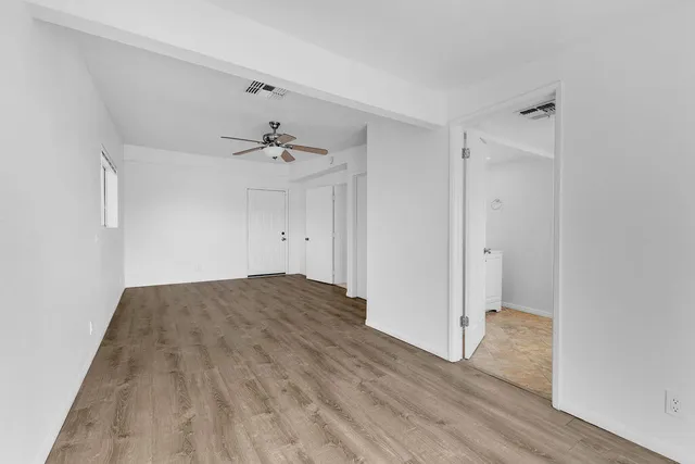 a bedroom with bed and a potted plant