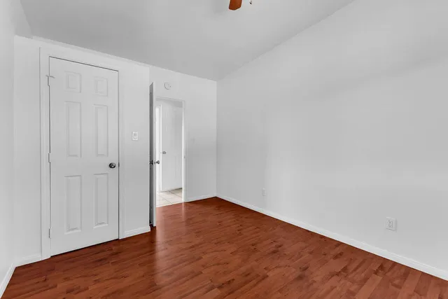 a view of a dry yard with wooden fence