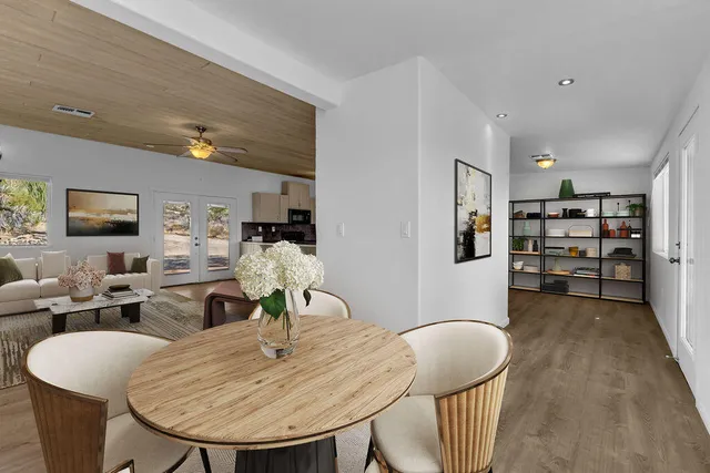 a large kitchen with stainless steel appliances granite countertop a lot of counter space and wooden floor