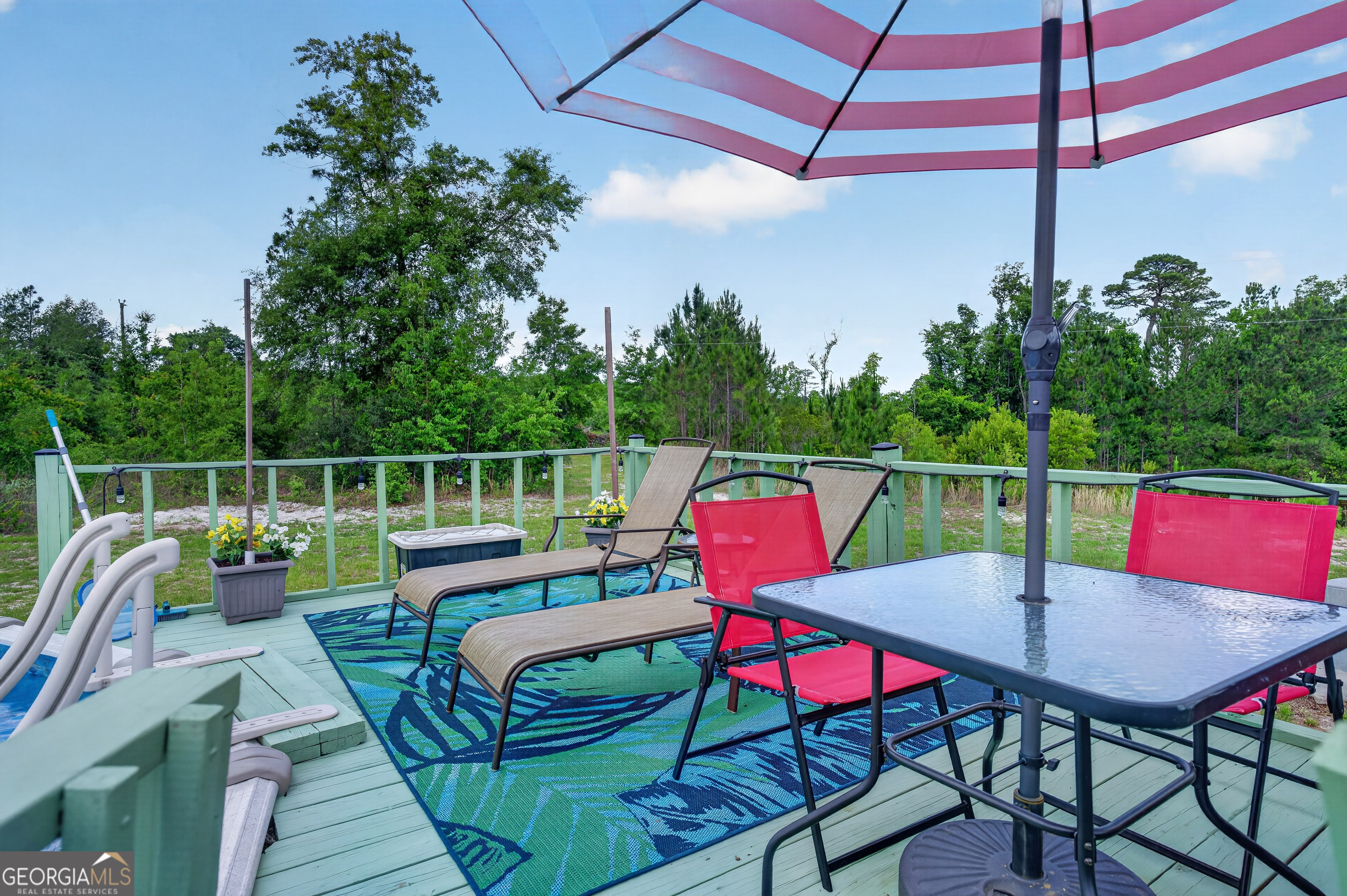 1953 Raybon Road West Hoboken, GA 31542 - Photo 27 of 31 a balcony with a table and chairs