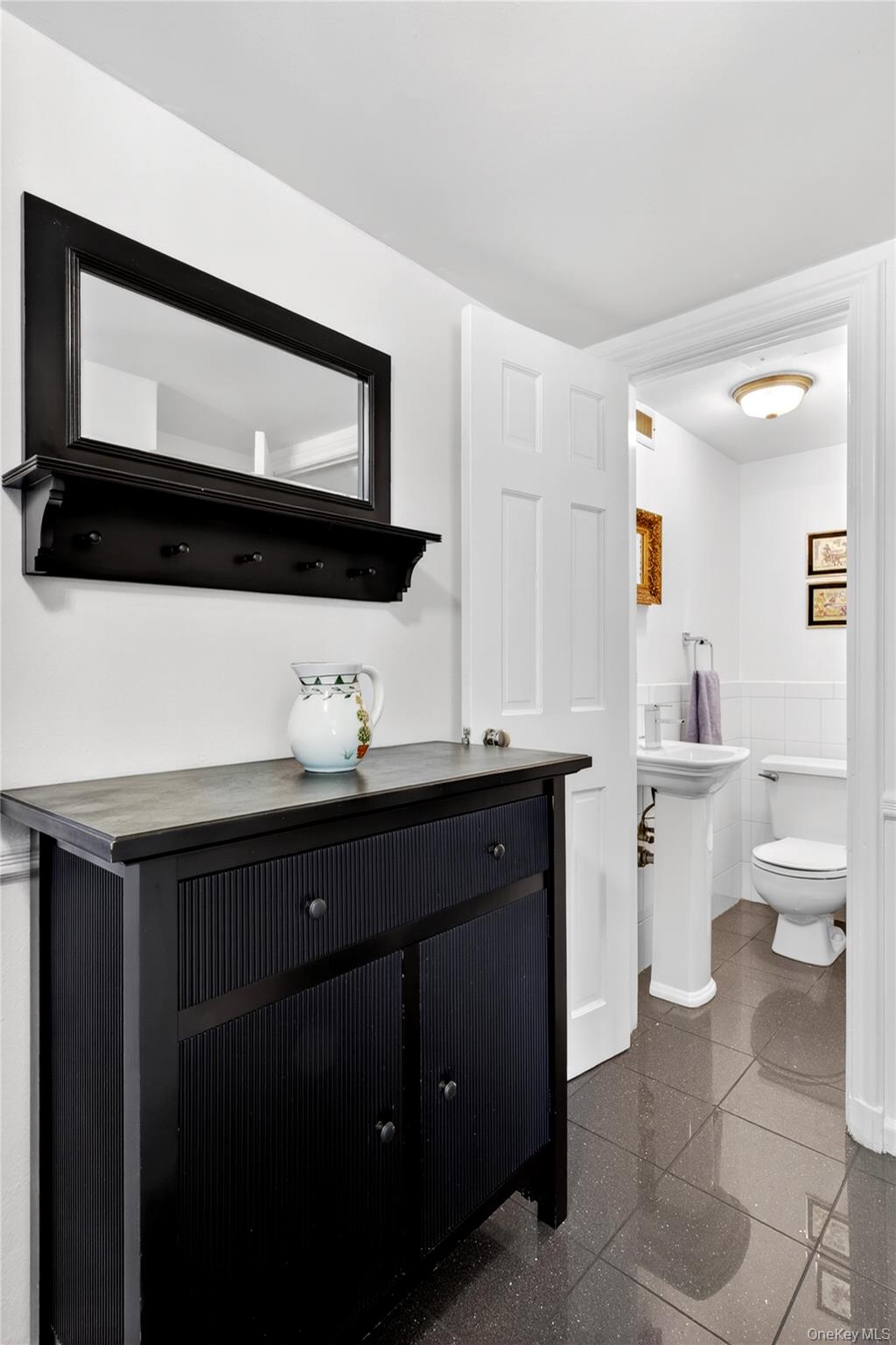 60 Mill Spring Road Manhasset, NY 11030 - Photo 10 of 18 a bathroom with a toilet a sink and a mirror