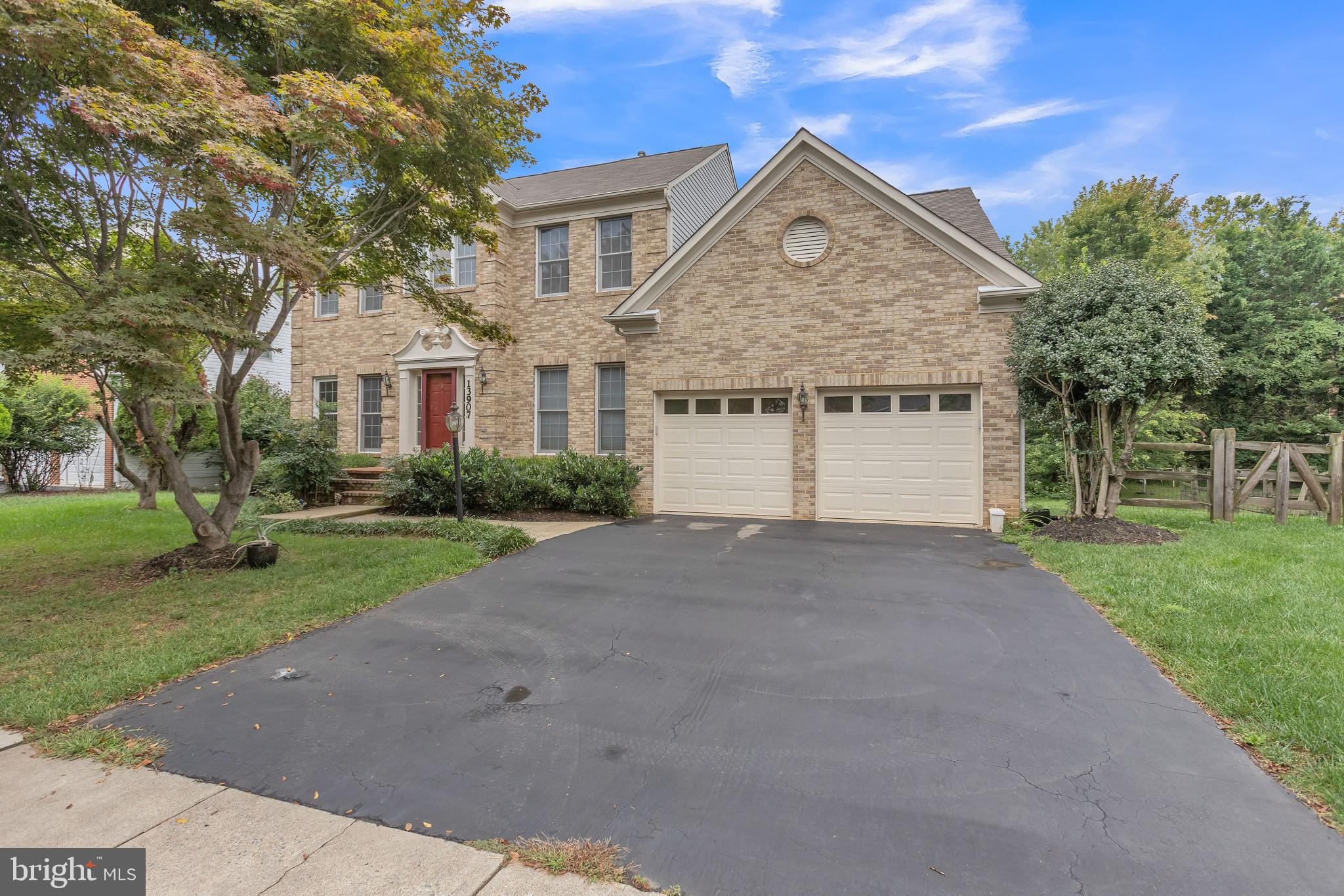 13907 Willow Tree Drive Rockville, MD 20850 - Photo 1 of 30 a front view of a house with a yard and garage
