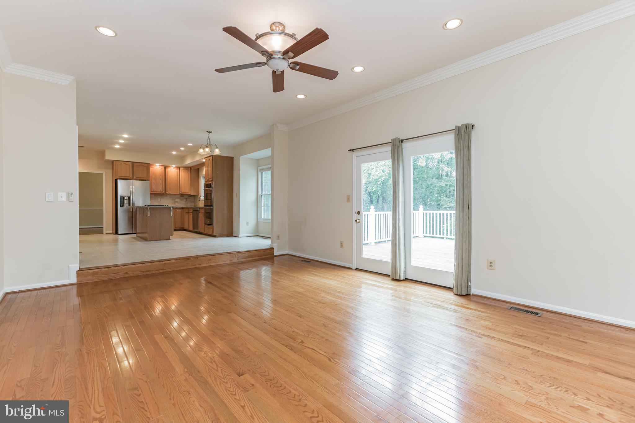 13907 Willow Tree Drive Rockville, MD 20850 - Photo 11 of 30 an empty room with wooden floor and windows