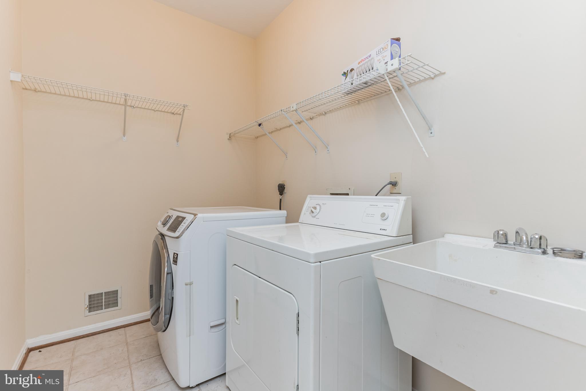 13907 Willow Tree Drive Rockville, MD 20850 - Photo 14 of 30 a utility room with dryer and washer