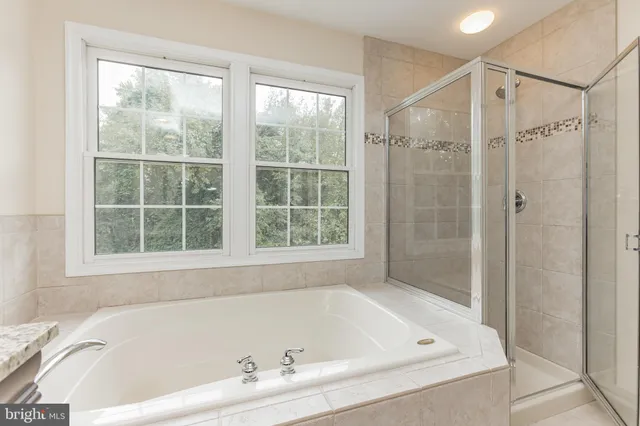 a white bath tub sitting next to a window