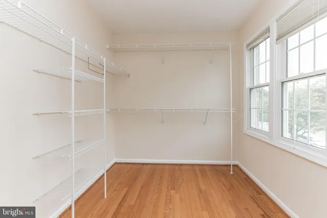 a view of a room with wooden floor and a window