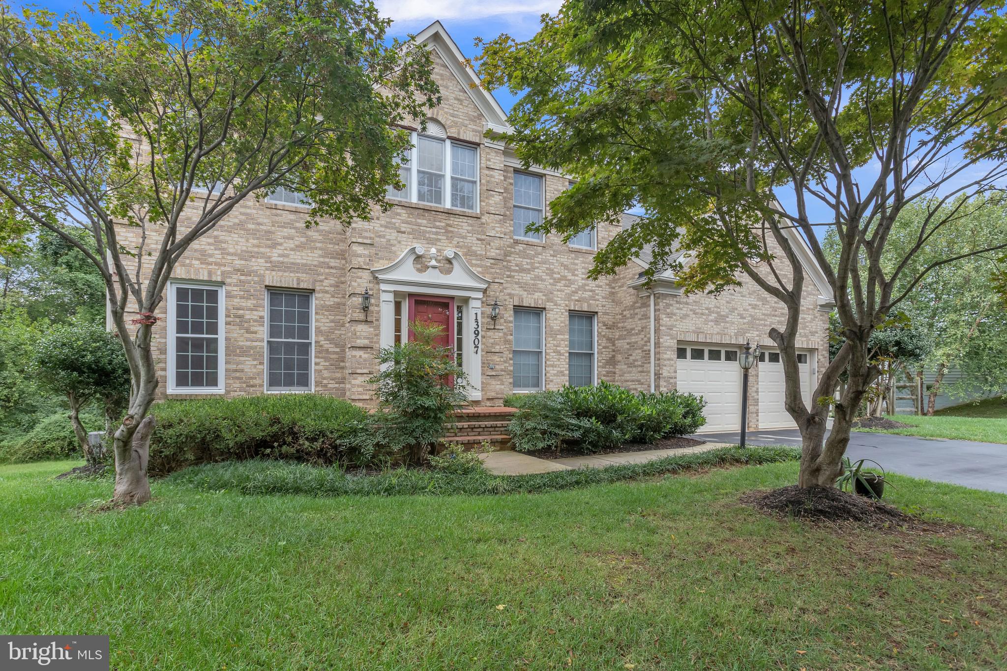 13907 Willow Tree Drive Rockville, MD 20850 - Photo 2 of 30 a front view of a house with a yard and trees
