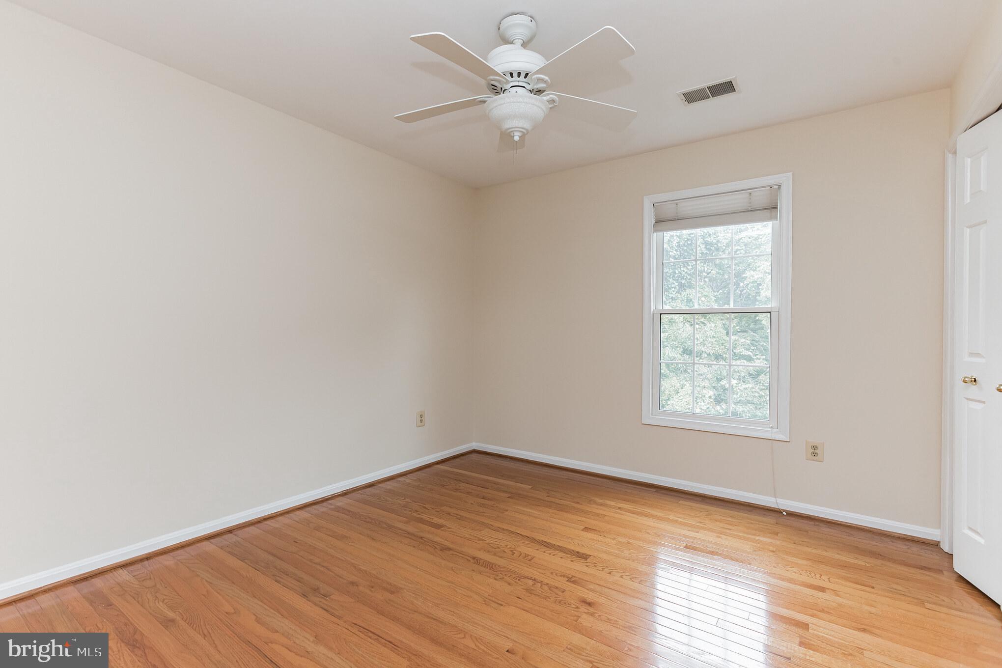 13907 Willow Tree Drive Rockville, MD 20850 - Photo 21 of 30 an empty room with a window and a ceiling fan