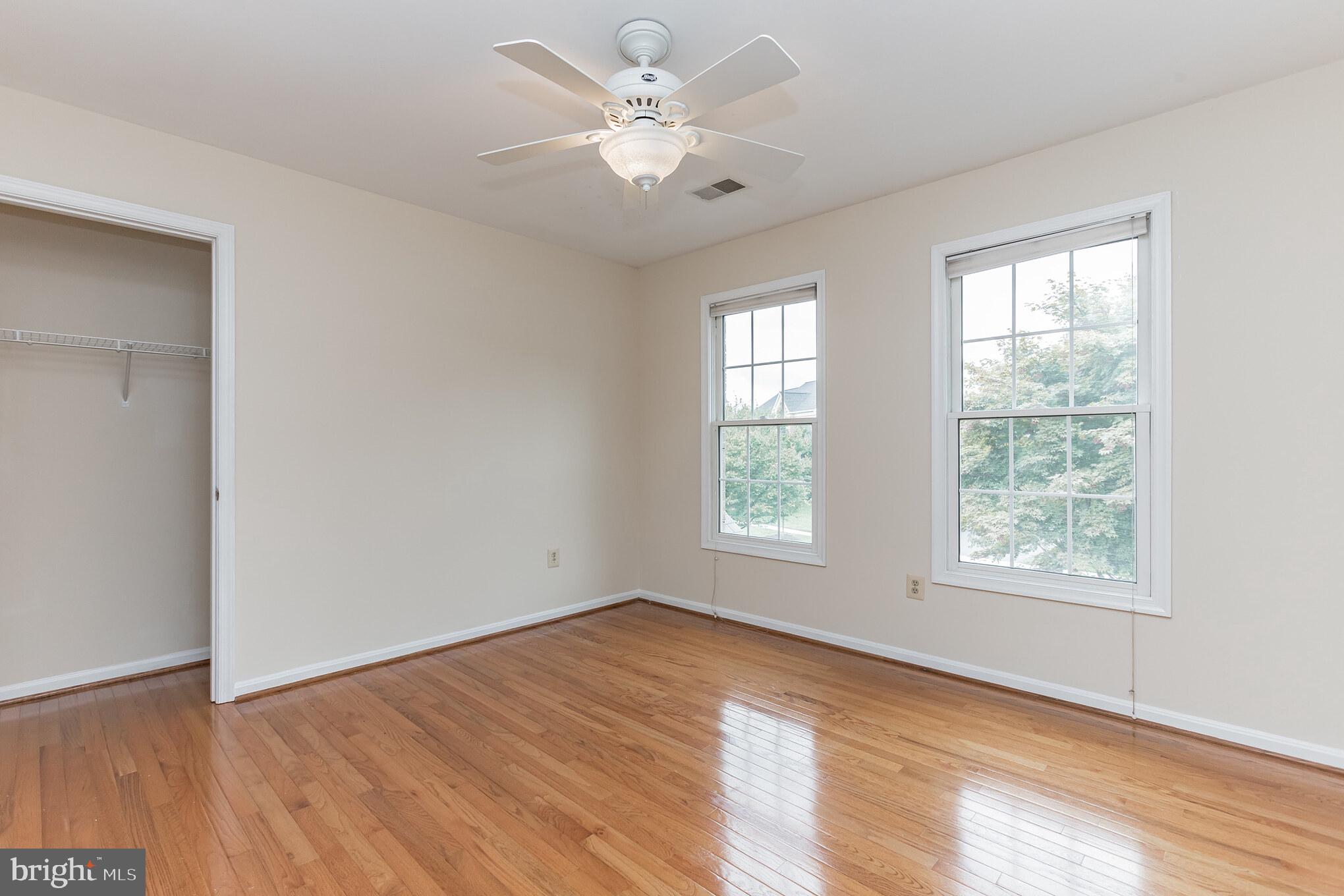 13907 Willow Tree Drive Rockville, MD 20850 - Photo 23 of 30 a view of an empty room with a window and wooden floor
