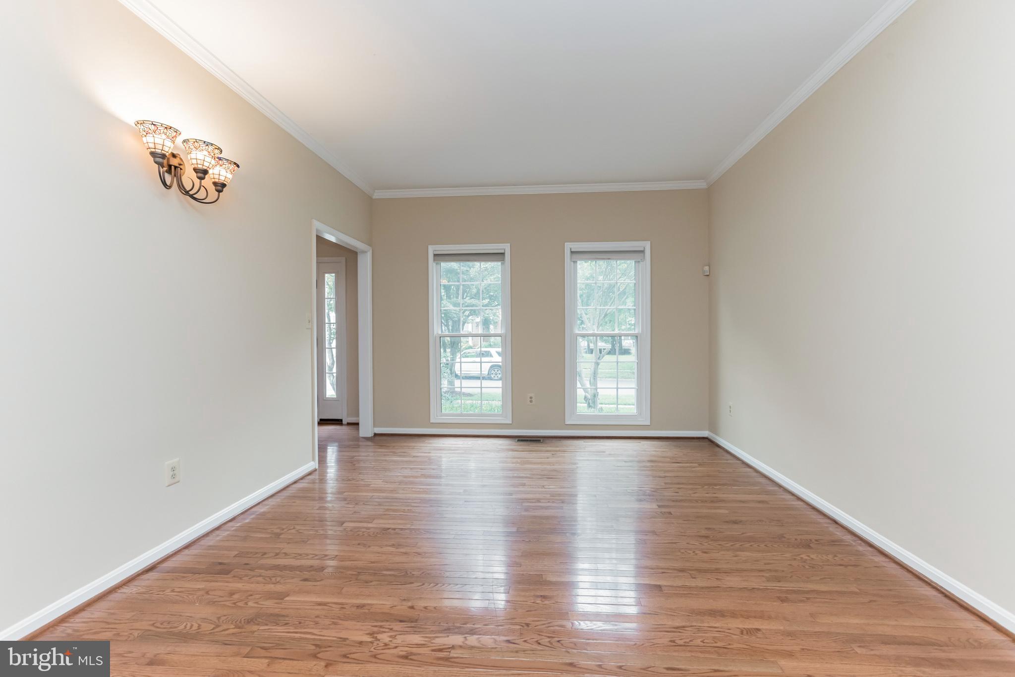 13907 Willow Tree Drive Rockville, MD 20850 - Photo 4 of 30 an empty room with wooden floor and window