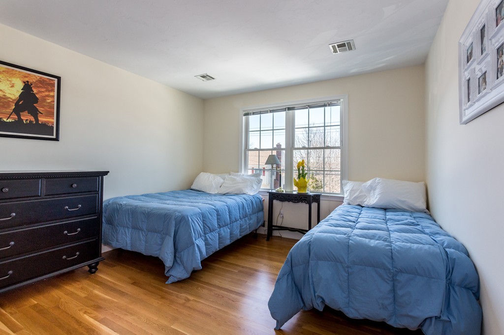 47 Crescent Road, Unit 47 Needham, MA 02494 - Photo 12 of 17 a bedroom with two beds and a dresser next to a window