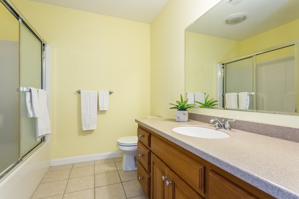 47 Crescent Road, Unit 47 Needham, MA 02494 - Photo 15 of 17 a bathroom with a granite countertop sink a toilet and shower