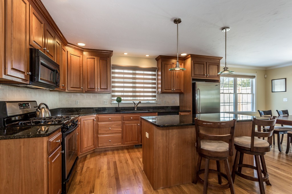 47 Crescent Road, Unit 47 Needham, MA 02494 - Photo 3 of 17 a kitchen with granite countertop a sink a counter space appliances and cabinets